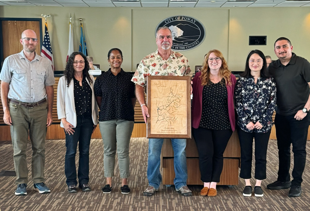 Photo of CRB Executive Director Chris Harris, surrounded by CRB staff.