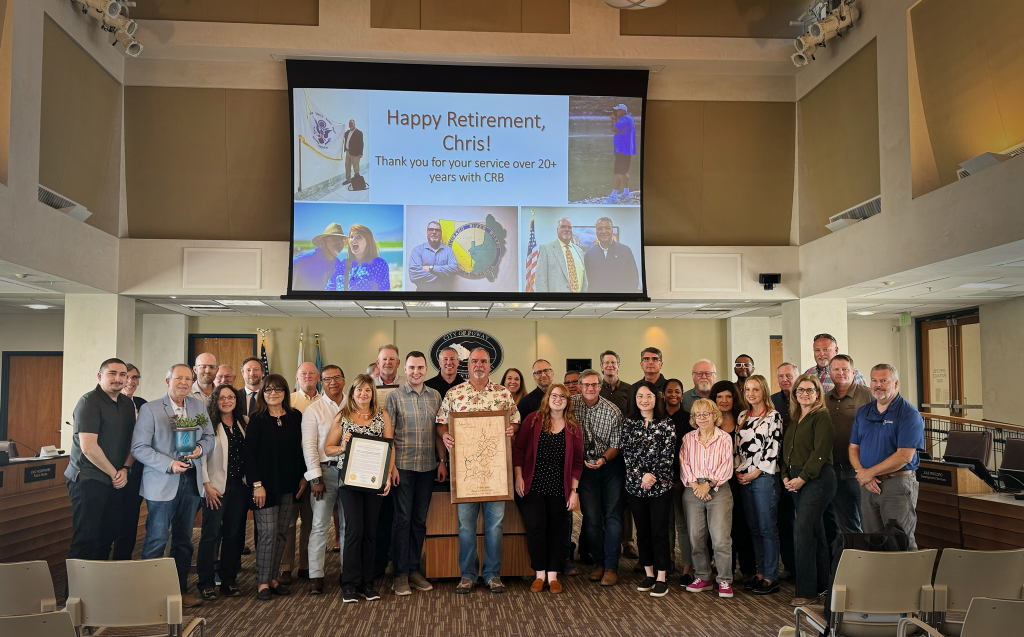 Photo of CRB Executive Director Chris Harris, surrounded by colleagues.